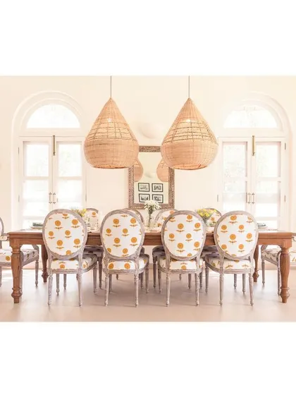 The dining room at Loto Bianco features custom cane lights designed by my studio and crafted by local artisans. The cheerful, block-printed upholstery on the chairs adds a touch of playfulness to the elegant, sun-drenched space.
