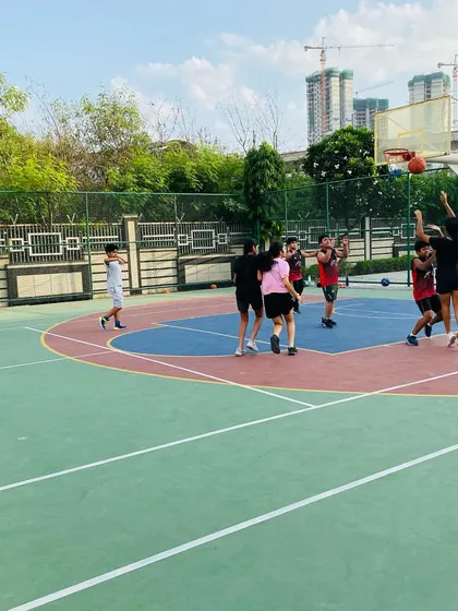 A female player goes up for a jump shot.