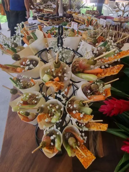 Our appetizer cones are filled with a mix of savory bites, olives, and fresh vegetables. The cone makes it an easy-to-carry snack for guests at a busy store launch or networking event.