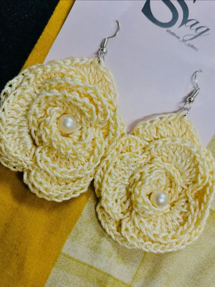 A pair of my handmade rose earrings with pearl centers. This design is a versatile piece of floral jewelry that can be dressed up or down.