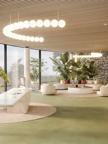 A wide view of the reception and lounge, where modern furniture and lighting contrast with the raw, natural stone wall.