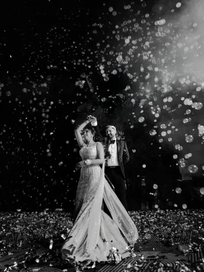 Under a sky of bubbles, the Sangeet night comes alive. I use dramatic lighting and creative angles to capture the energy of the dance floor and the couple's effortless rhythm.