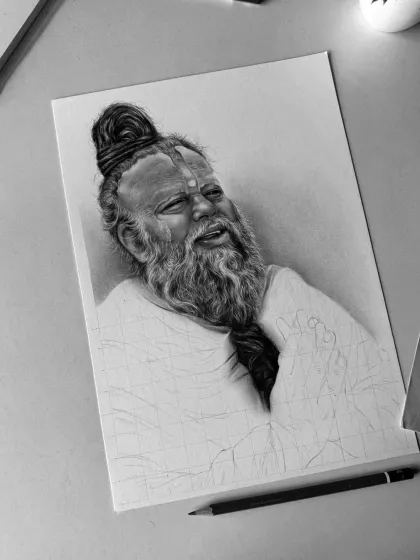 A work-in-progress image of my portrait of spiritual leader Premanand Govind Maharaj. Here, the face is nearly complete, showing the detailed shading on his beard and skin, while the rest of the drawing is still outlined.