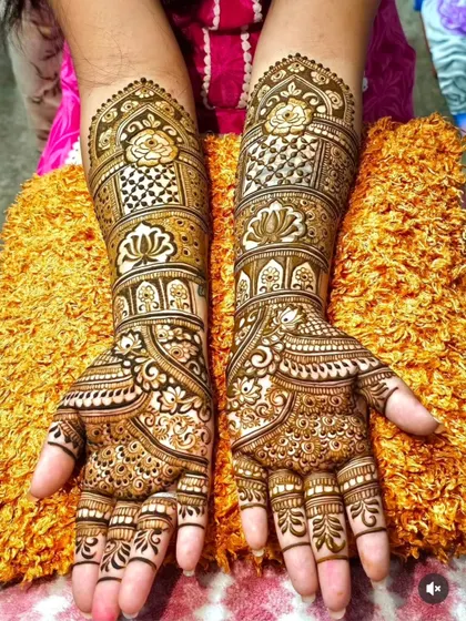 A classic and dense bridal design covering the full forearm. This style features traditional motifs like roses and lotuses set within architectural frames, with detailed work on the fingers.