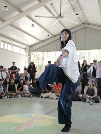 A dancer hitting a high kick during the battles at Spectra, showcasing incredible flexibility and style.