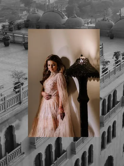 A beautiful portrait of the bride in her Sangeet gown, set against the architectural beauty of the palace venue.
