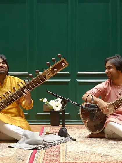 Sharing a smile with my brother during our sitar duet recording. The joy of creating music together is something I am deeply grateful for.