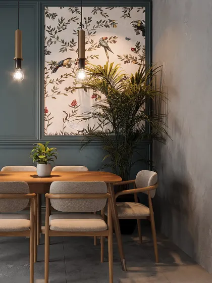 A different angle of the teal dining room, showing how the natural light interacts with the dark walls and highlights the indoor plant.