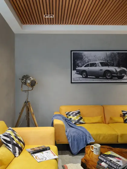 In the Grey Apartment, I used a cool grey palette accented with vibrant yellows to introduce warmth and character. The living room features a bold yellow sofa, a vintage car photograph, and a studio-style floor lamp.