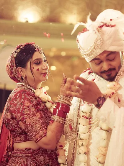 A playful and candid moment during the varmala ceremony, capturing the fun and games that are part of the tradition.
