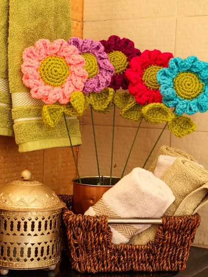 Happy Flowers. A colourful bouquet of my large crochet flowers, styled in a bathroom to add an unexpected pop of colour and joy.