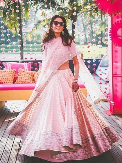 For daytime functions or summer weddings, I can stitch lighter lehengas like this beautiful pink one. The focus here is on elegant fabric and a comfortable, flowing silhouette.