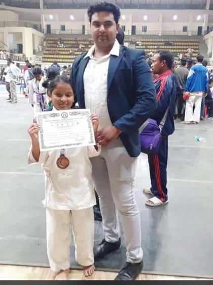 Our young student Trisha with her bronze medal at the state level championship.