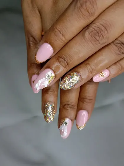 A different angle of the pink and gold shell-accented bridal nails, perfect for a beach wedding or a bride who loves subtle, unique details.