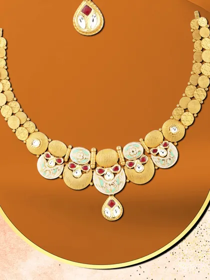 She glows with grace in this contemporary necklace. The design uses circular motifs with red and white enamel, creating a piece that is both elegant and eye-catching.