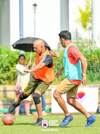 A player with a knee brace shows his determination, focusing on the ball during a competitive match. It's all about passion and perseverance.