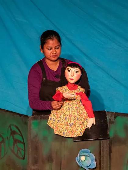A close-up of the Aisha puppet, showing the detailed craftsmanship and expressive face that helps her connect with the audience.