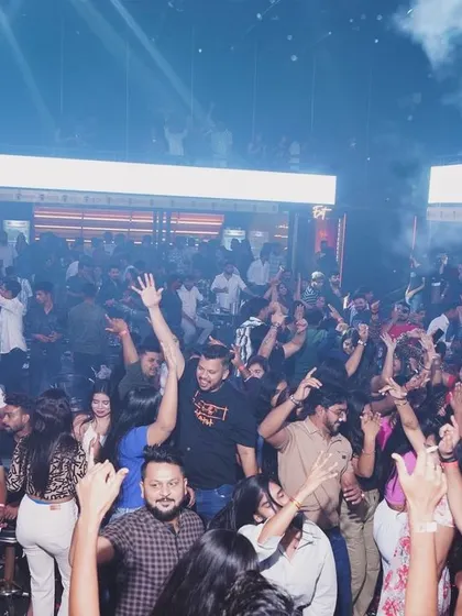 Hands in the air under a haze of smoke at Hyper Club. This is what a high-energy Bollywood set looks like.
