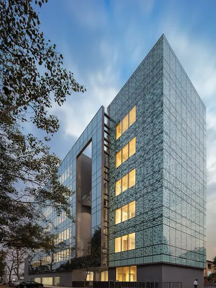This is Delhi’s first LEED Platinum Commercial Office Building, designed by us. Its north-facing orientation and strategic placement of service cores minimize solar heat gain, ensuring 100% daylighting and creating a 'blinds-free' workspace.