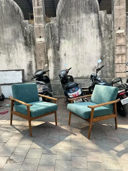 Another view of the teal lounge chairs, showcasing their simple yet comfortable design.