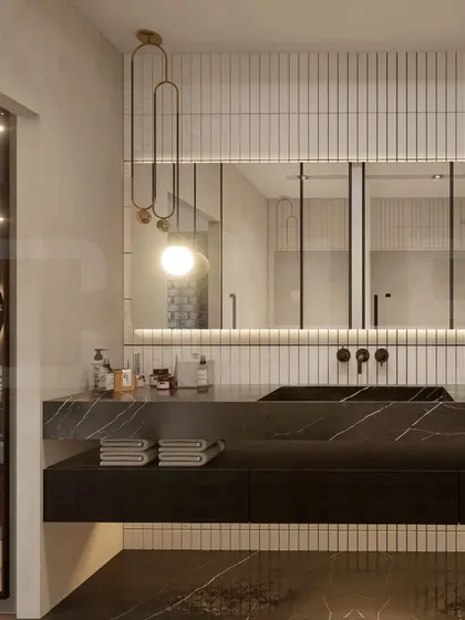 This design showcases our use of rich materials, featuring a black marble countertop and backsplash with dramatic veining. The vertical tilework and elegant pendant light add texture and a touch of glamour.