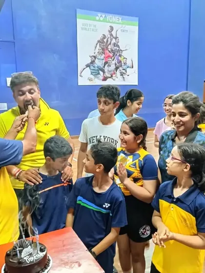 Sharing a piece of birthday cake with the coach. These are the moments that build our strong community bond.