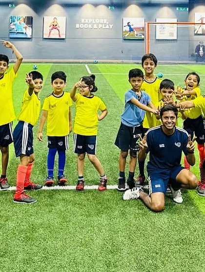 A team photo with coaches and players, all smiles. We are a close-knit community at ESSB.