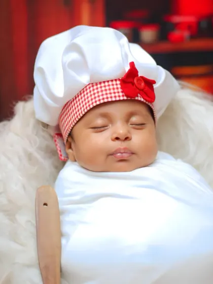 Another sweet close-up of the newborn chef, capturing the tiny details of the costume and props.