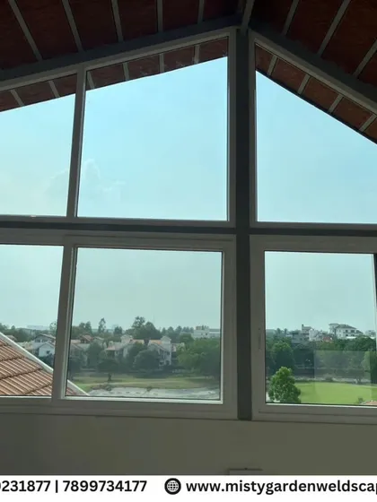A stunning view from inside a terrace room at Prestige Augusta Golf Villa, framed by custom-fitted UPVC windows that offer panoramic views while providing insulation and noise reduction.
