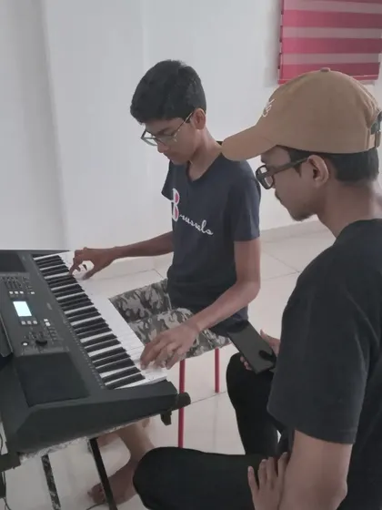 A student getting focused instruction on the keyboard. These moments of dedicated practice lead to great performances.