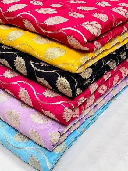 To show the beautiful range I carry, here is a stack of my designer crepe jacquard fabrics. The woven leaf pattern has a subtle sheen, available in a palette from bold fuchsia to classic black.
