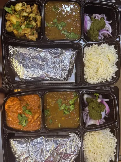A look at two different meal options. One thali has jeera aloo and the other has soya chaap, both served with a comforting dal.