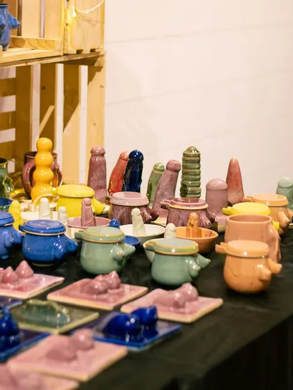 A vibrant and playful collection of colorful pottery from one of our students at the GLAZED exhibit.