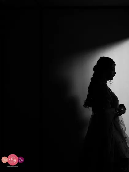 A dramatic silhouette of the bride, Ami, using light and shadow to create a powerful and artistic black and white portrait.