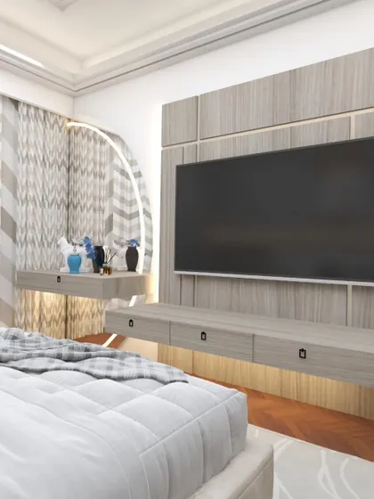 A bedroom TV unit designed with a floating console and a unique curved dressing table extension. The integrated lighting behind the mirror adds a functional and glamorous touch.