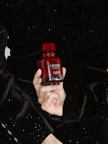 A model holding the personalized Givenchy bottle. This shows how a small touch of engraving adds a layer of luxury and individuality.