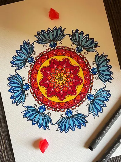 Finding peace in every stroke. This colorful piece features beautiful lotus patterns in blue, surrounded by a warm and vibrant center.