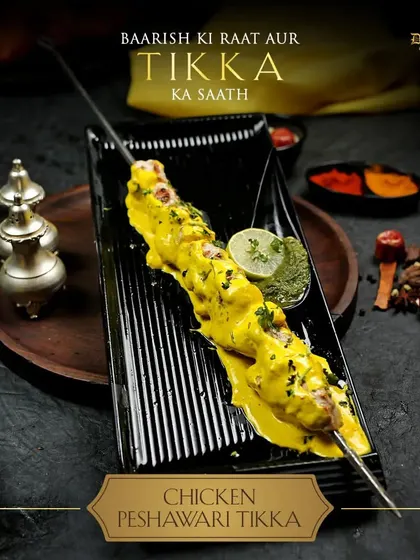 Baarish ki raat aur tikka ka saath. A rainy night is the perfect setting for my Chicken Peshawari Tikka. This single skewer, glistening with creamy sauce and served with green chutney, is the ultimate comfort food for a cozy evening.