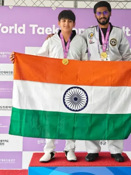 A duplicate of a proud moment, holding the Indian flag with my student.