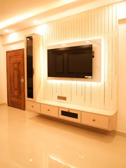 A slightly different angle of the same TV unit, showcasing its clean lines and the beautiful interplay of light and shadow on the fluted panels.