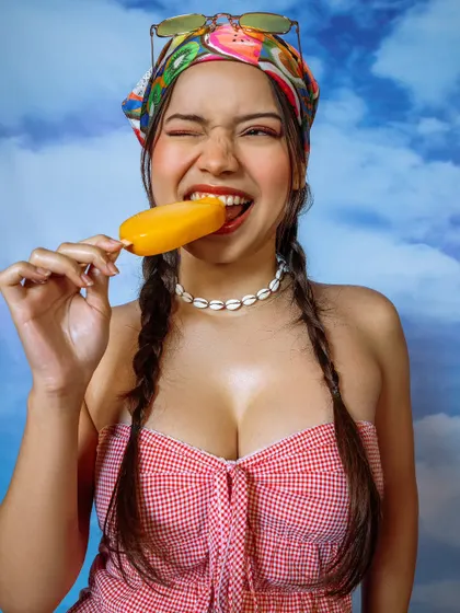 A playful and engaging lifestyle shot for a summer campaign. The model's expression is fun and relatable, perfect for social media.