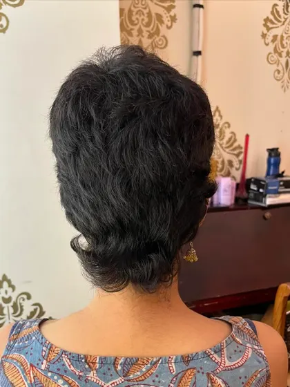 The back view of the final styled curly mullet.