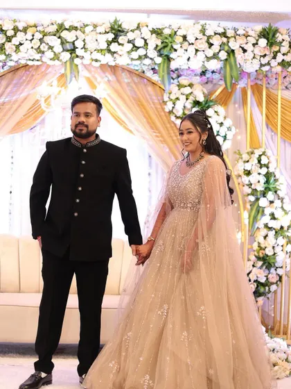 Holding hands and ready to start their new chapter. The bride's side profile shows off her beautiful curly hairstyle and glowing makeup.