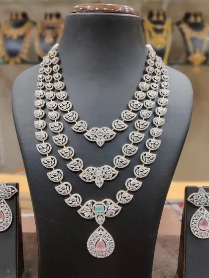 A modern and elegant three-layered necklace with pastel-colored stones. This is a beautiful, lightweight option for pre-wedding events.