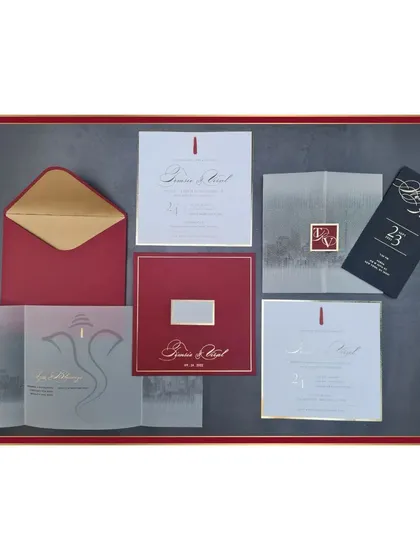 A full view of our chic New York City-themed invitation suite. The design combines a bold red, black, and white color palette with gold foil details, a vellum overlay featuring the city skyline, and a modern Ganesha illustration for a touch of tradition.