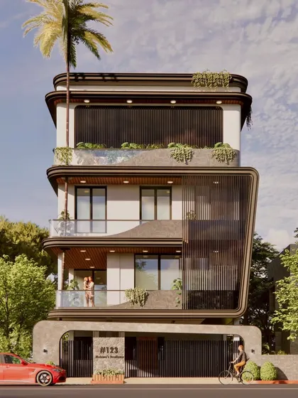 The flowing, curved lines of the facade wrap around the structure, creating a sense of movement. This G+3 contemporary home includes a home theatre and multi-car parking, designed for a future-ready lifestyle.
