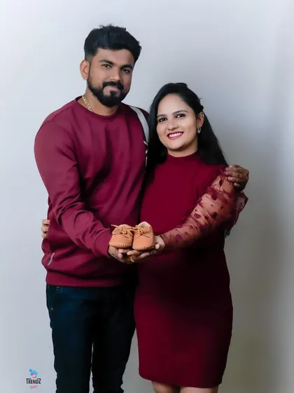 A sweet and simple pose. The couple holding up tiny baby shoes is a classic and adorable way to announce their coming joy.