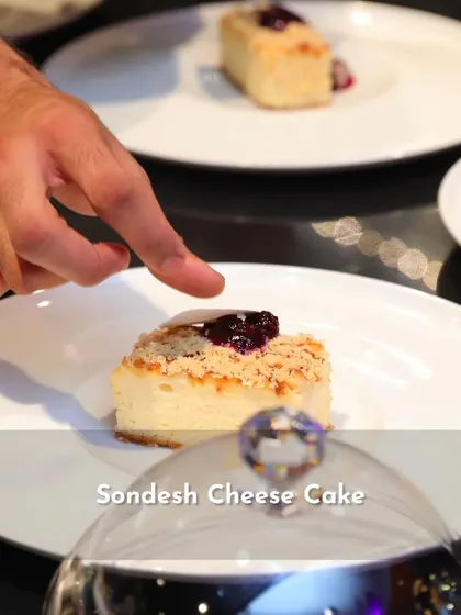 Sondesh Cheesecake, a fusion dessert from the 'Sounds of India' menu that combines the flavors of Bengal with a classic cheesecake.