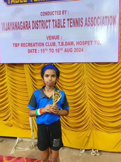 Ghanavi proudly holds her trophy after a successful tournament organized by the Vijayanagara District Table Tennis Association. Her focus and hard work are truly paying off.