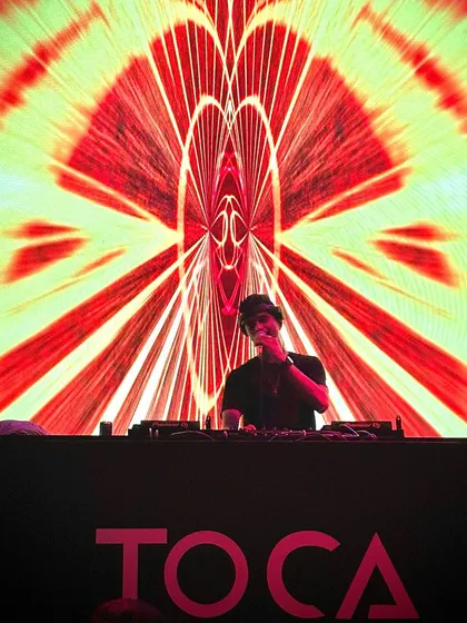 Doing my best and letting God do the rest. A powerful silhouette against the vibrant visuals at Toca, a moment of gratitude and focus.